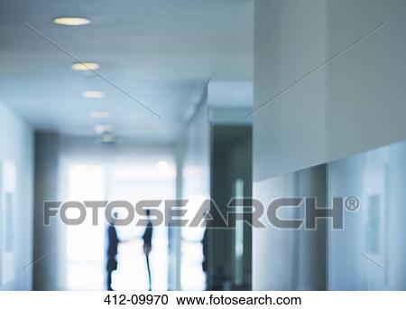 Stock Image - Silhouette of businessmen shaking hands in office. Fotosearch