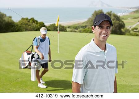 Caddy and golfer on golf course View Large Photo Image Stock Photo - Caddy and golfer on golf course. Fotosearch