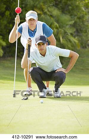 Caddy and golfer on putting green View Large Photo Image Stock Image - Caddy and golfer on putting green. Fotosearch