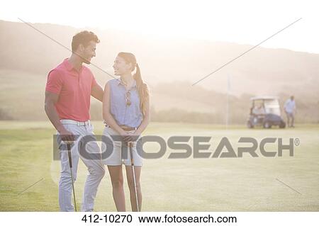Couple on golf course View Large Photo Image Stock Image - Couple on golf course. Fotosearch