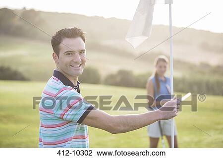 Couple on golf course View Large Photo Image Stock Image - Couple on golf course. Fotosearch