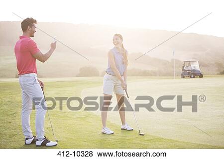 Stock Photo - Couple playing golf. Fotosearch