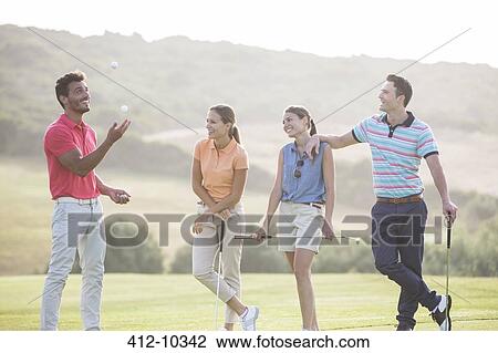 Friends juggling golf balls on golf course View Large Photo Image Stock Image - Friends juggling golf balls on golf course. Fotosearch