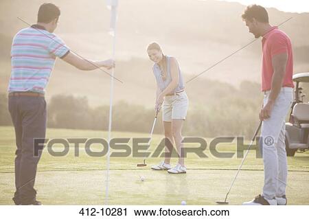 Friends playing golf on course View Large Photo Image Stock Image - Friends playing golf on course. Fotosearch