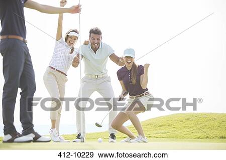 Friends playing golf on course View Large Photo Image Stock Photo - Friends playing golf on course. Fotosearch