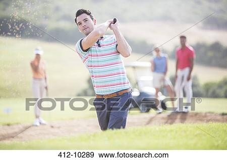 Friends playing golf on course View Large Photo Image Stock Photo - Friends playing golf on course. Fotosearch