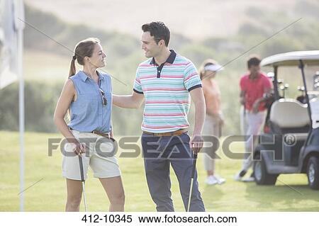 Friends playing golf on course View Large Photo Image Stock Photography - Friends playing golf on course. Fotosearch