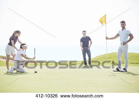 Stock Photograph - Friends playing golf. Fotosearch