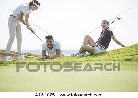 Friends playing on golf course View Large Photo Image Stock Image - Friends playing on golf course. Fotosearch