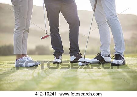 Friends standing on golf course View Large Photo Image Stock Image - Friends standing on golf course. Fotosearch