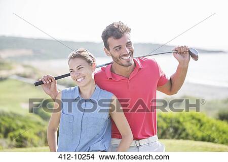 Picture - Happy couple on golf course. Fotosearch