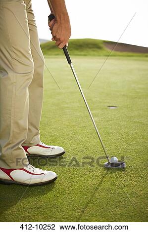 Man preparing to putt on golf course View Large Photo Image Stock Image - Man preparing to putt on golf course. Fotosearch