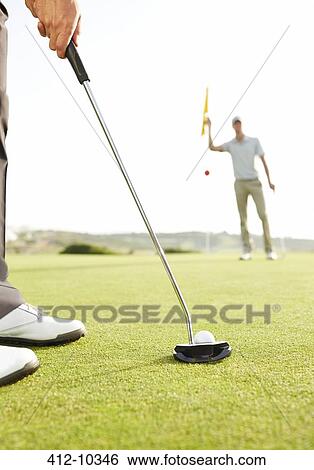 Stock Photograph - Man putting golf ball. Fotosearch
