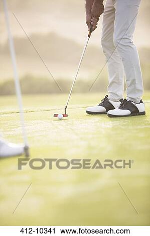 Man putting on golf course View Large Photo Image Stock Image - Man putting on golf course. Fotosearch