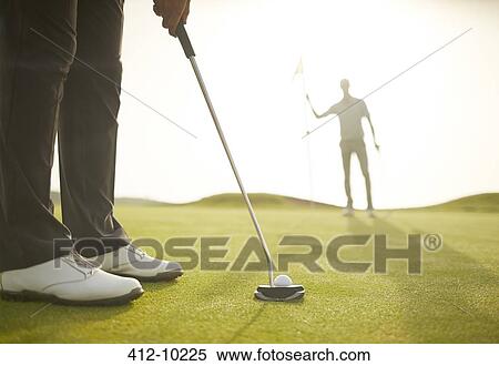 Man putting on golf course View Large Photo Image Stock Photography - Man putting on golf course. Fotosearch