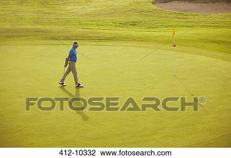 Man walking on golf course View Large Photo Image Stock Image - Man walking on golf course. Fotosearch