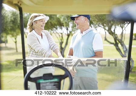 Senior couple laughing on golf course View Large Photo Image Stock Image - Senior couple laughing on golf course. Fotosearch