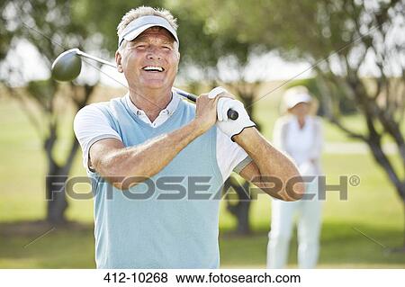 Stock Photo - Senior couple on golf course. Fotosearch