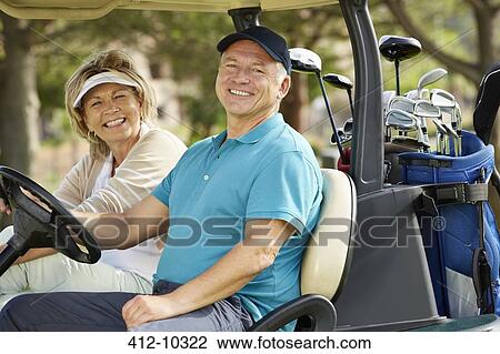 Senior couple smiling in golf cart View Large Photo Image Stock Image - Senior couple smiling in golf cart. Fotosearch