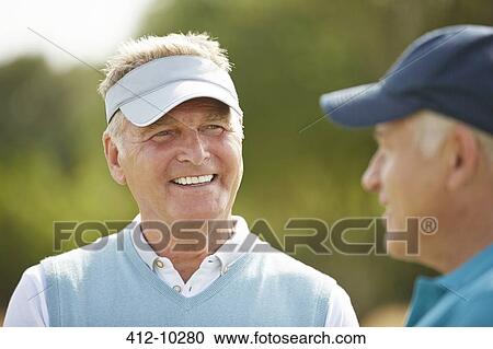Senior golfers talking View Large Photo Image Stock Image - Senior golfers talking. Fotosearch