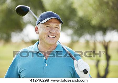Stock Photo - Senior man holding golf club. Fotosearch