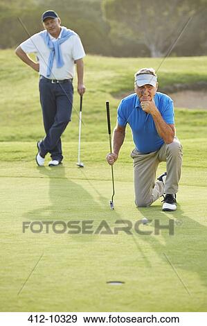 Stock Photo - Senior men on golf course. Fotosearch