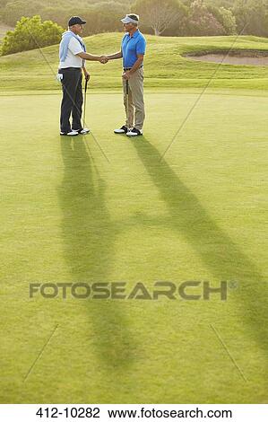 Senior men shaking hands on golf course View Large Photo Image Stock Image - Senior men shaking hands on golf course. Fotosearch