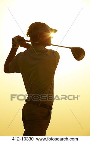 Silhouette of man swinging golf club View Large Photo Image Stock Image - Silhouette of man swinging golf club. Fotosearch