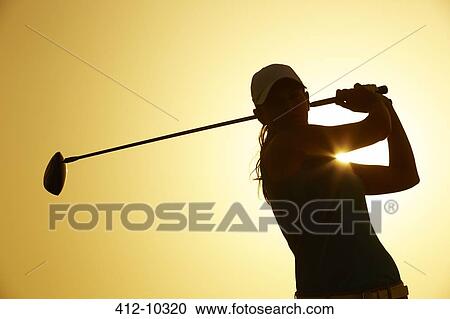 Stock Image - Silhouette of woman playing golf on course. Fotosearch