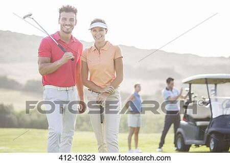 Smiling couple on golf course View Large Photo Image Stock Image - Smiling couple on golf course. Fotosearch