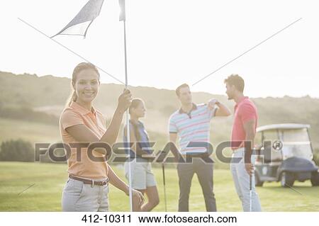 Smiling friends on golf course View Large Photo Image Stock Image - Smiling friends on golf course. Fotosearch