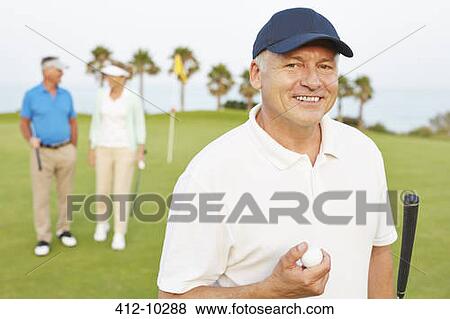 Stock Photo - Smiling senior man on golf course. Fotosearch