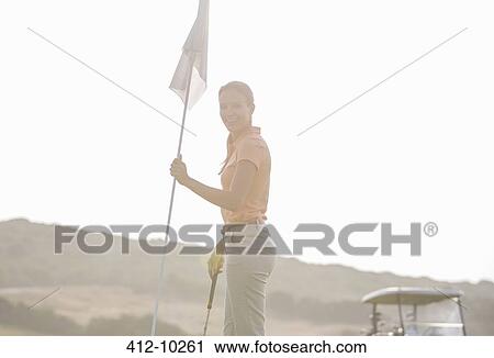 Stock Image - Woman hold golf flag. Fotosearch