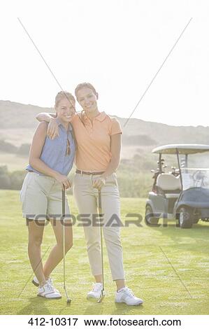 Women playing golf on course View Large Photo Image Stock Photo - Women playing golf on course. Fotosearch