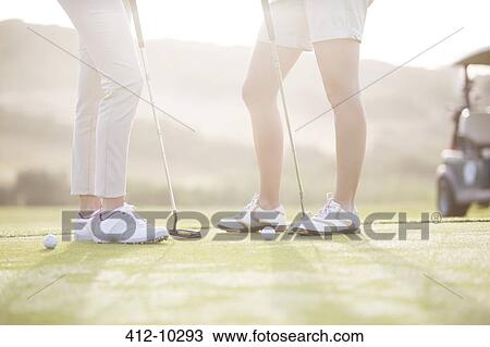 Women standing on golf course View Large Photo Image Stock Image - Women standing on golf course. Fotosearch