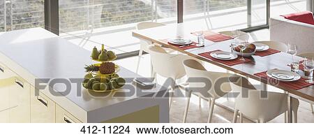 Breakfast bar and set table in modern living space View Large Photo Image Picture - Breakfast bar and set table in modern living space. Fotosearch