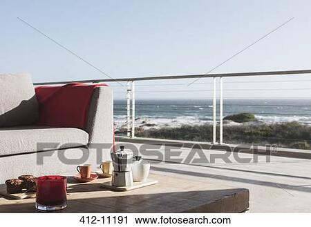 Breakfast on coffee table on modern patio overlooking ocean View Large Photo Image Stock Image - Breakfast on coffee table on modern patio overlooking ocean. Fotosearch