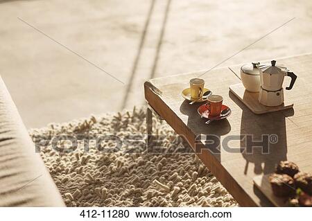 Coffee pot and espresso cups on coffee table in living room View Large Photo Image Stock Image - Coffee pot and espresso cups on coffee table in living room. Fotosearch