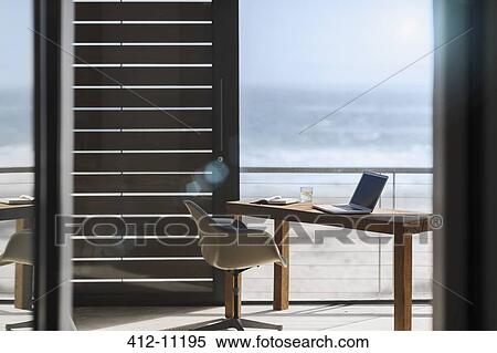 Desk and chair in modern home office overlooking ocean View Large Photo Image Stock Photography - Desk and chair in modern home office overlooking ocean. Fotosearch