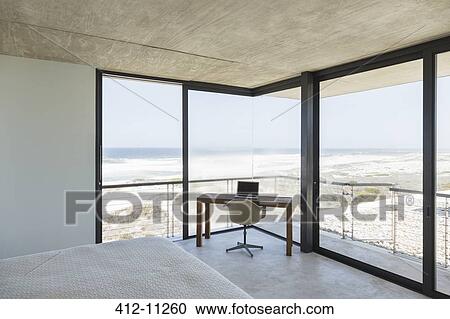 Desk in modern bedroom overlooking ocean View Large Photo Image Stock Image - Desk in modern bedroom overlooking ocean. Fotosearch