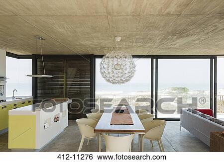 Stock Photograph - Dining room and kitchen overlooking ocean. Fotosearch