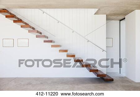 Stock Image - Floating staircase in modern house. Fotosearch