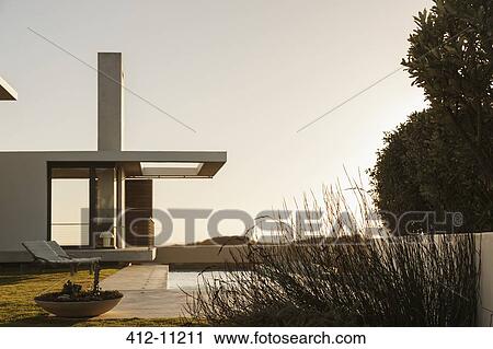 Lap pool along modern house at sunset View Large Photo Image Stock Image - Lap pool along modern house at sunset. Fotosearch