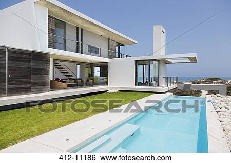 Lap pool along modern house View Large Photo Image Stock Photograph - Lap pool along modern house. Fotosearch
