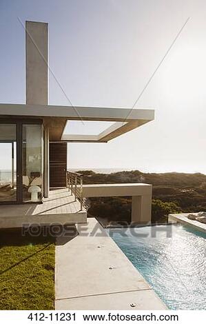 Lap pool outside modern house View Large Photo Image Stock Image - Lap pool outside modern house. Fotosearch
