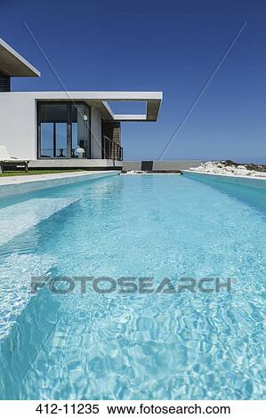 Lap pool outside modern house View Large Photo Image Stock Photography - Lap pool outside modern house. Fotosearch