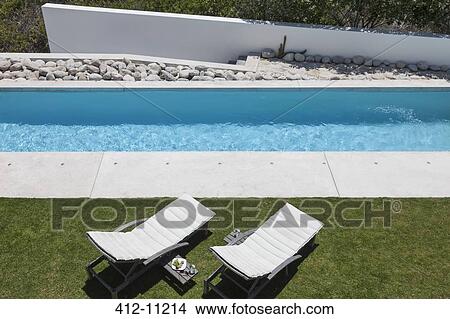 Lounge chairs by modern lap pool View Large Photo Image Picture - Lounge chairs by modern lap pool. Fotosearch