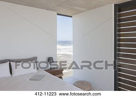 Stock Image - Modern bedroom with ocean view. Fotosearch