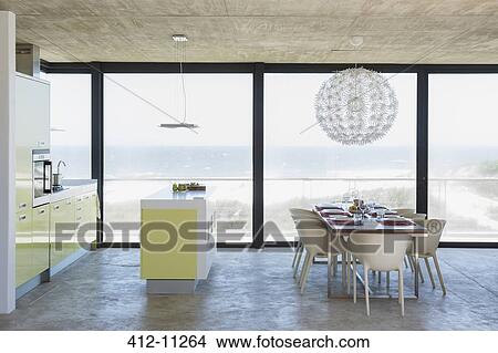 Modern dining room and kitchen overlooking ocean View Large Photo Image Picture - Modern dining room and kitchen overlooking ocean. Fotosearch