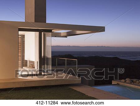 Modern house illuminated at dusk View Large Photo Image Picture - Modern house illuminated at dusk. Fotosearch